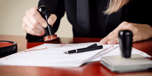 notary signing a document