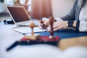 person doing notary on laptop