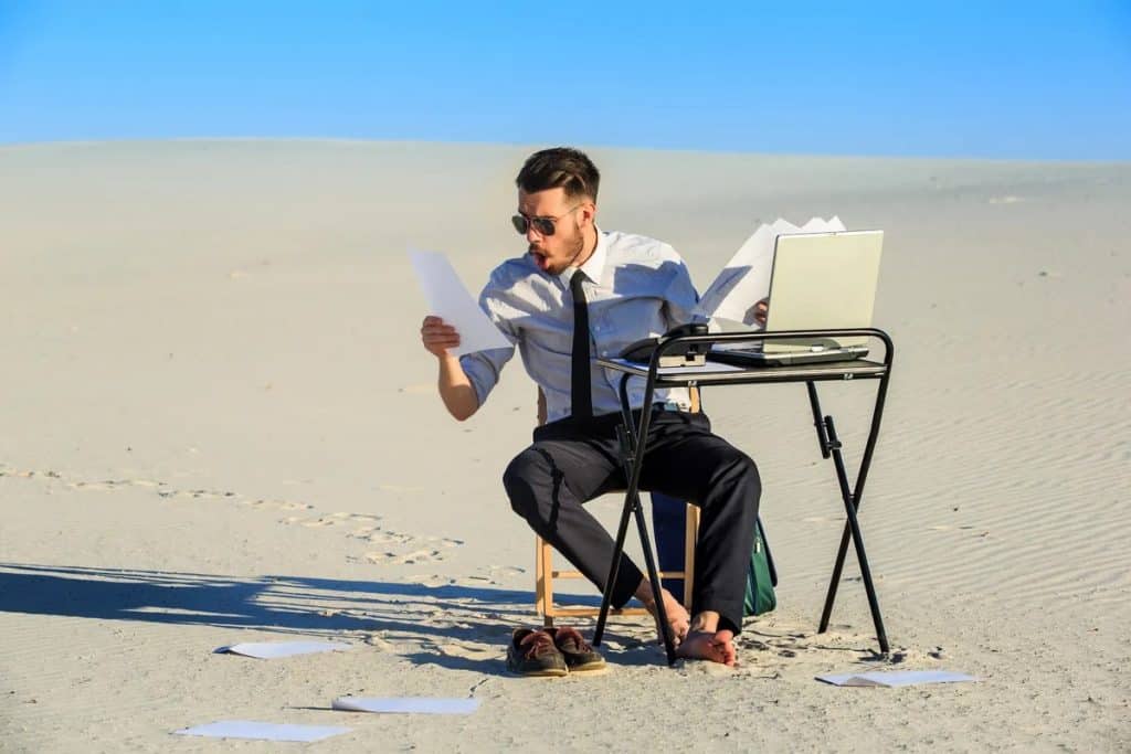 man at his desk in the desert