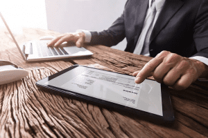 man typing on computer and tablet