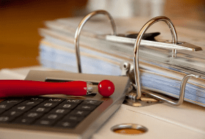 binder on table with company documents