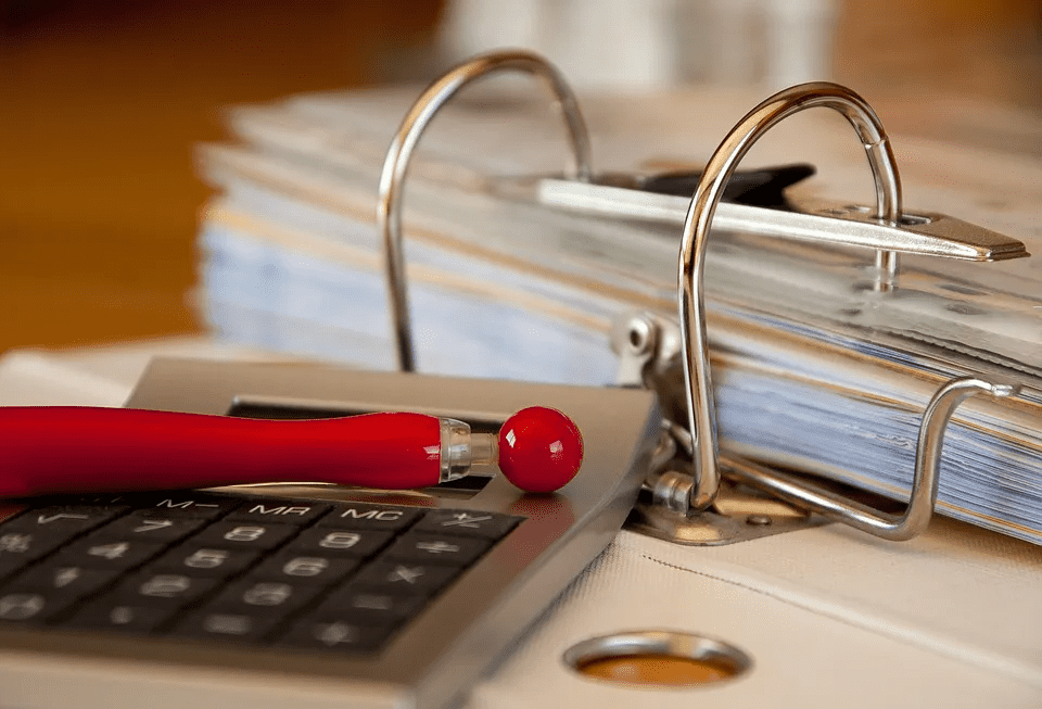 binder on table with company documents