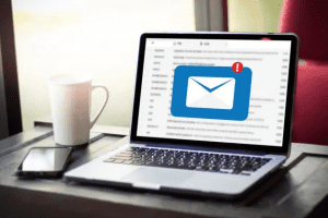 Image of laptop computer sitting on a table showing a new mail message