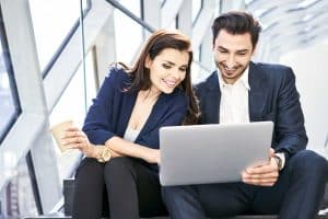 A man and a woman engaged in a conversation about the top six US states for noncitizens to launch a startup business.