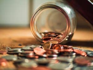 Image of a Coin Being poured out of a Glass Jar, Representing Affordable LLC Formation