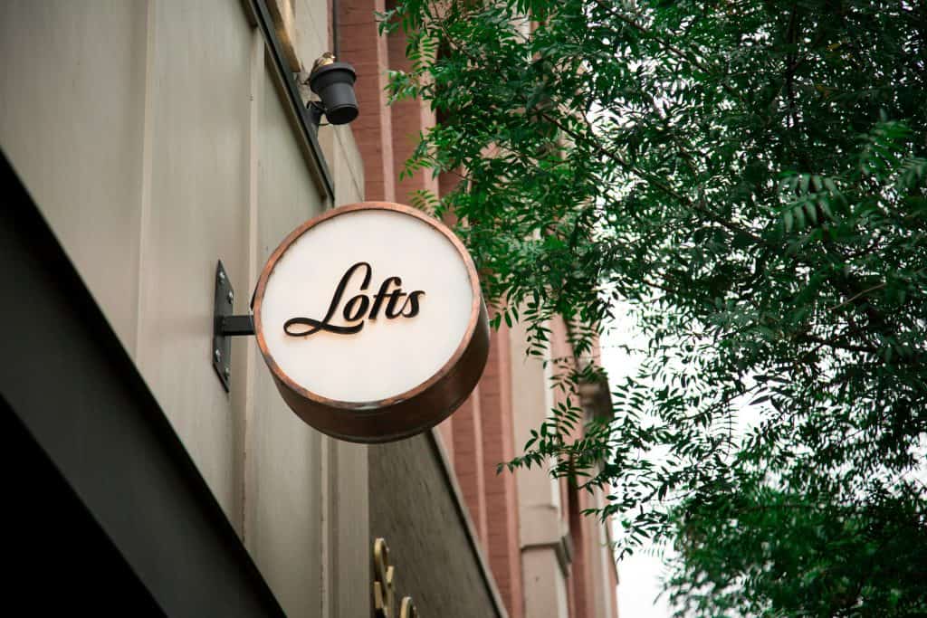 Signage reading "Lofts" on a building structure, representing the concept of trademarking a business name​