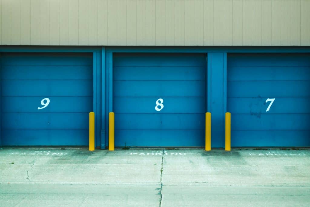 Row of numbered roller shutter doors, representing the concept of starting a storage unit business with no money​