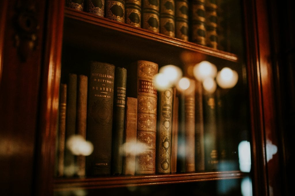 Corporate bylaws template with open book and eyeglasses on a desk