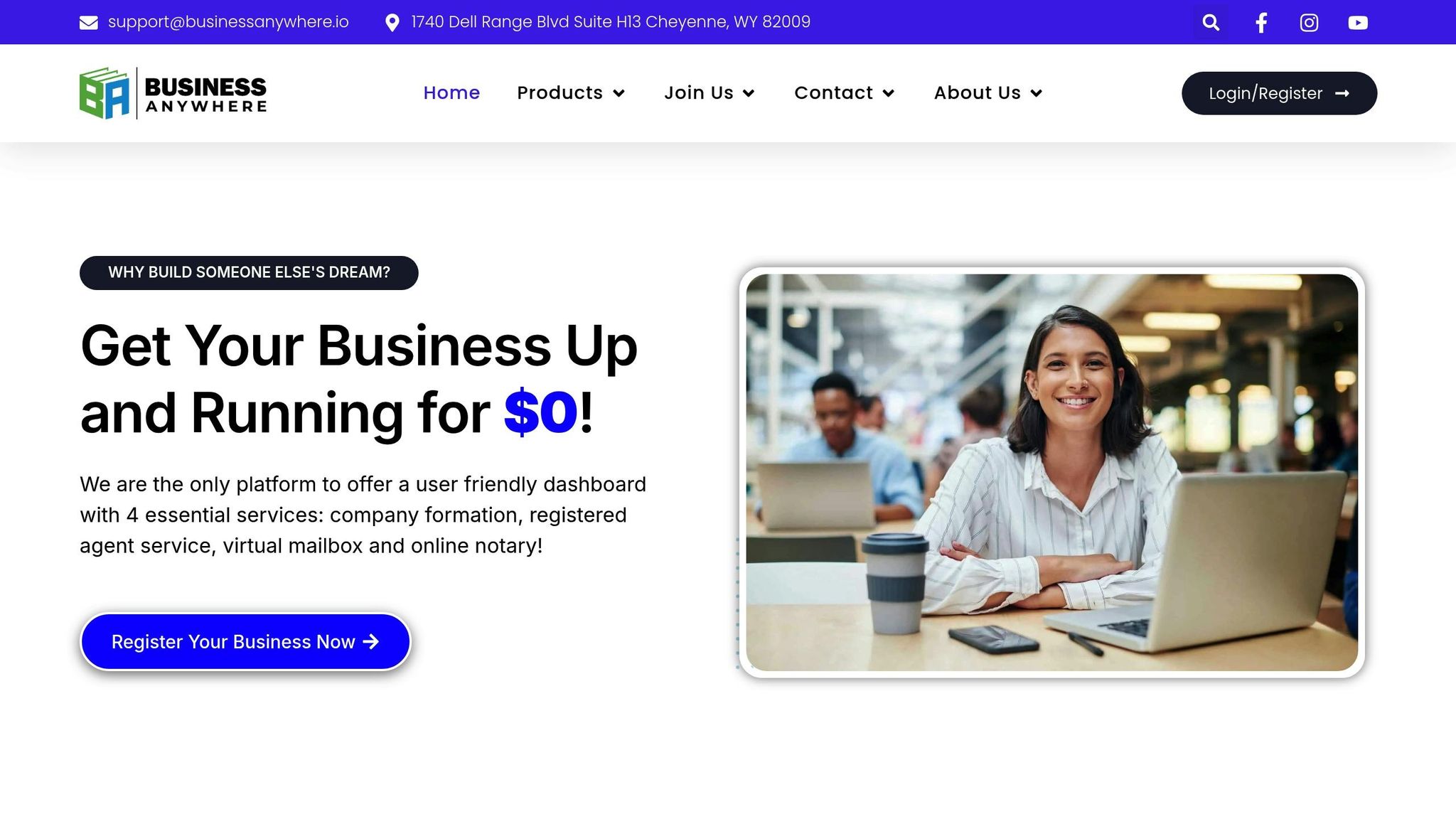 Smiling woman using a laptop at a modern coworking space, representing virtual business solutions for LLCs.