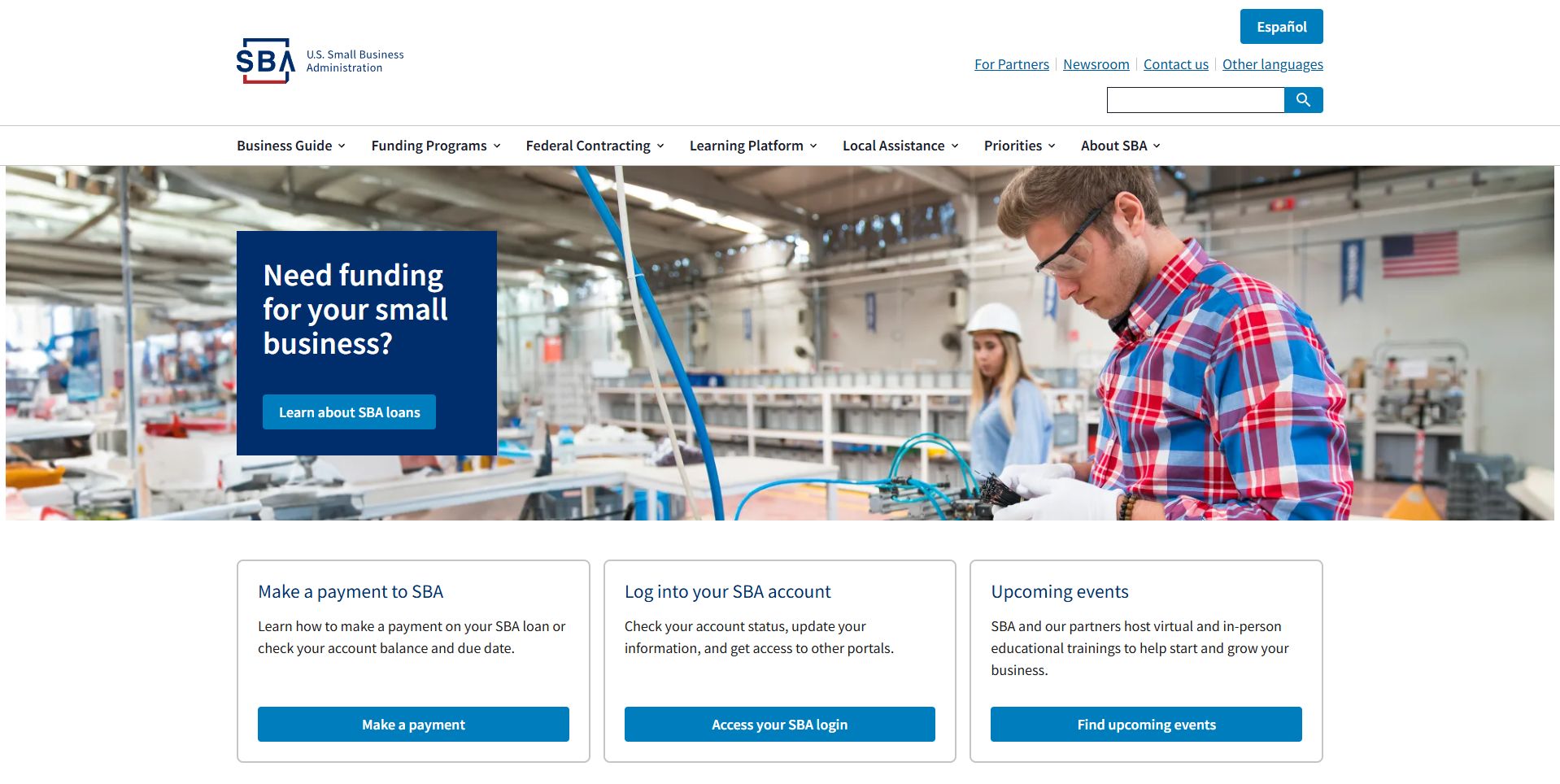 Small business owner working in a manufacturing facility with a focus on securing funding options for growth.