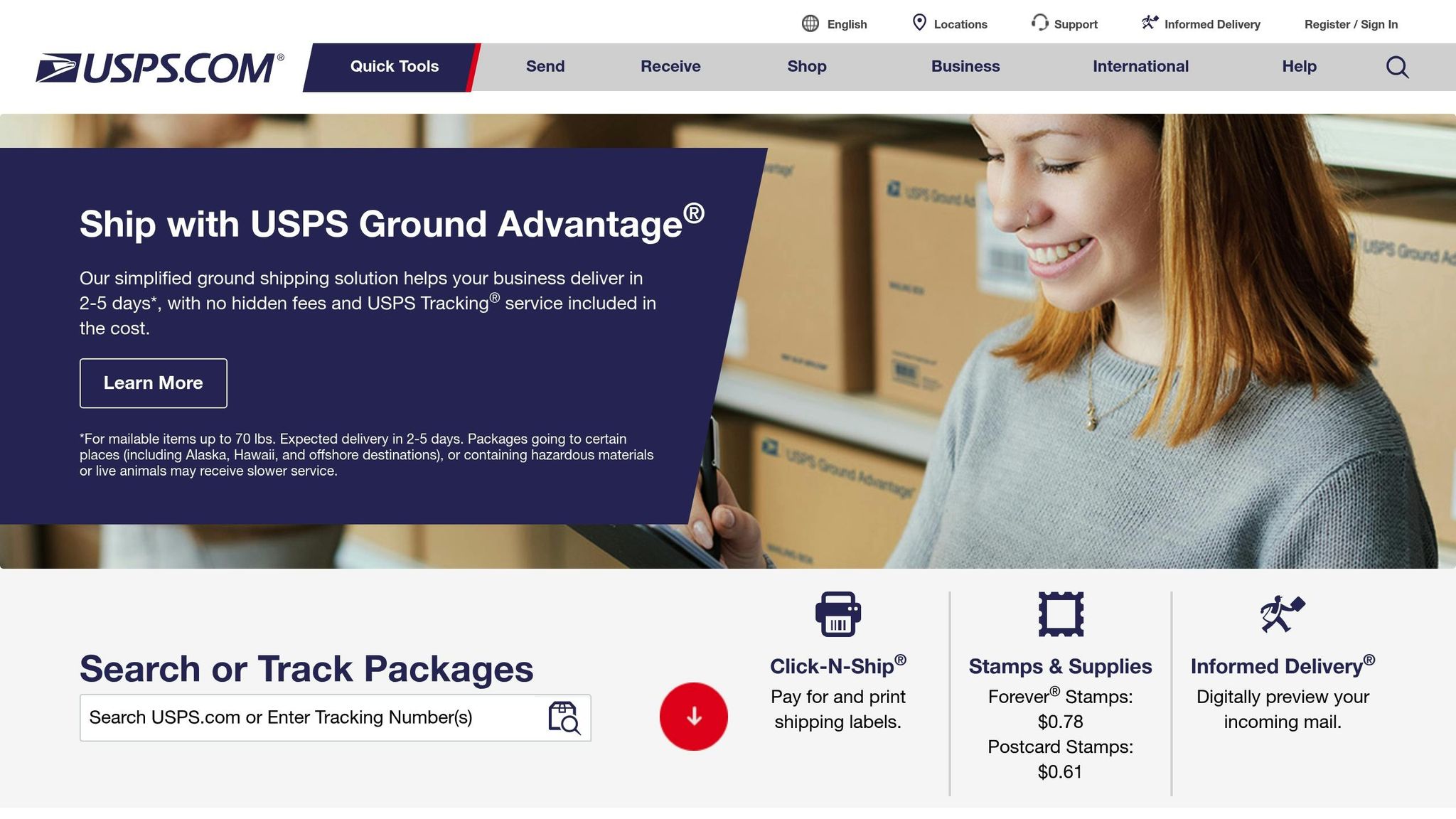 A smiling woman using a laptop with USPS shipping boxes in the background, representing virtual address and shipping solutions for businesses.