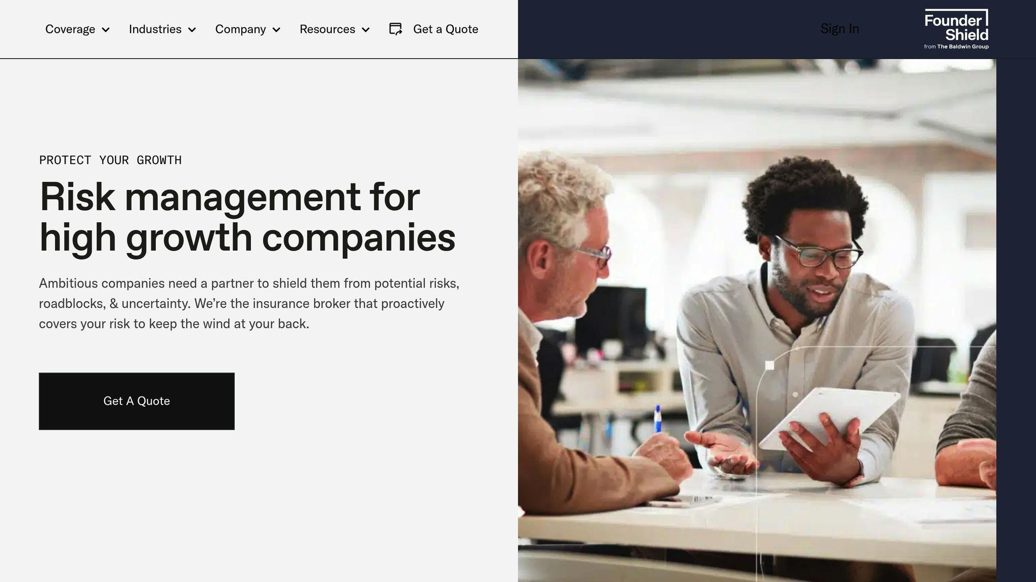 Two professionals discussing risk management strategies for high-growth companies in a modern office setting.