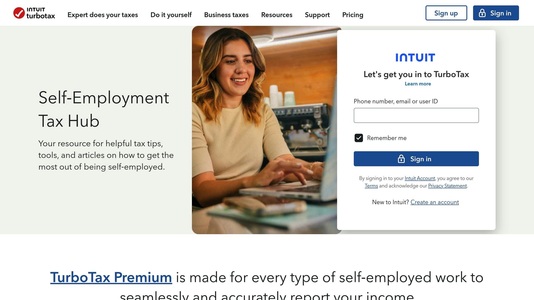 A smiling woman working on her laptop at a self-employment tax hub, representing small business owners managing taxes efficiently.