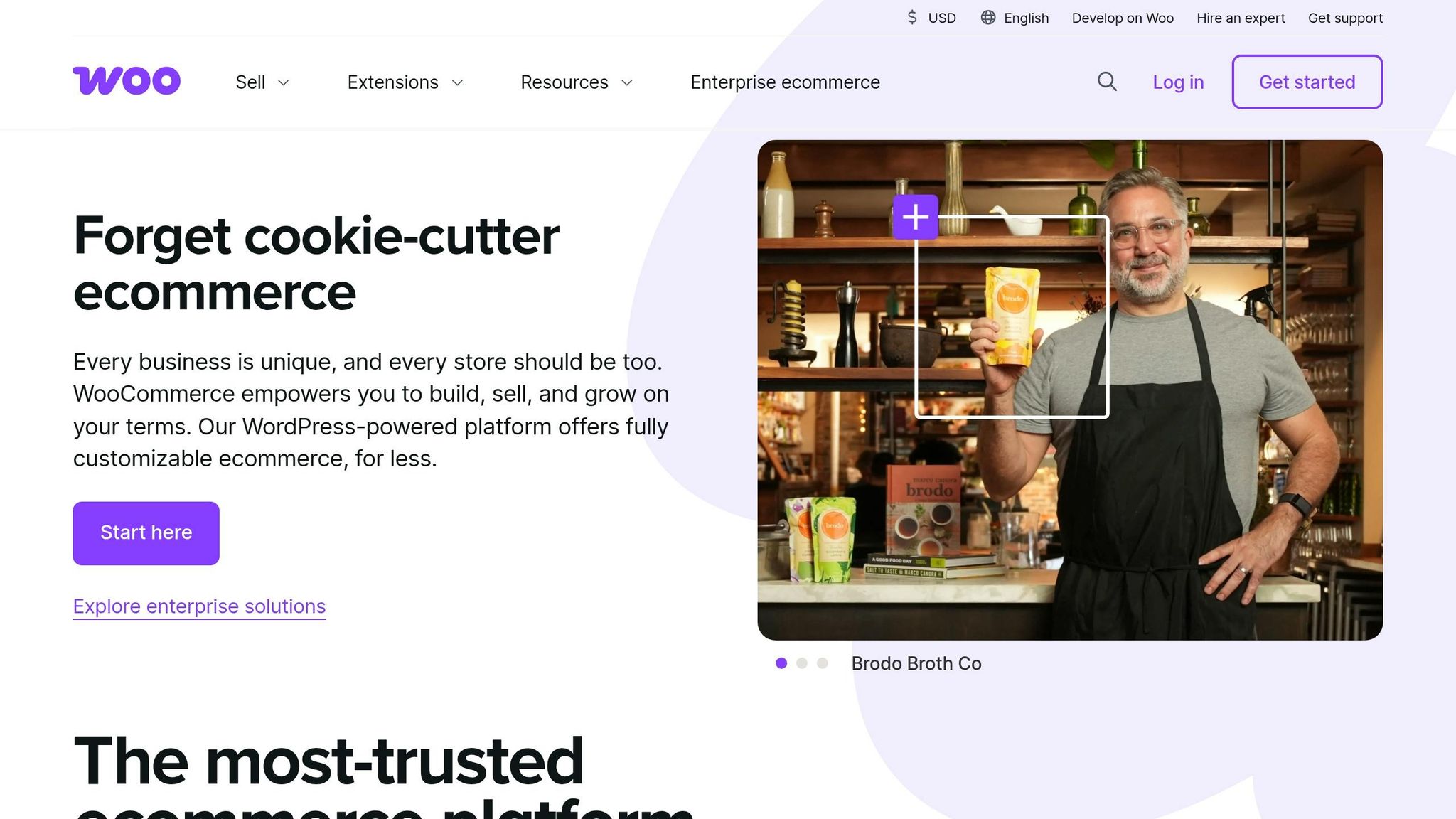 A smiling man in an apron holding a cup of broth in a cozy kitchen setting, representing e-commerce and online business solutions.