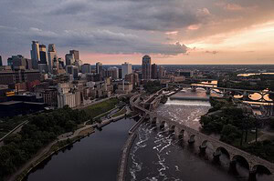 Minneapolis, Minnesota skyline and the Stone Arch Bridge at sunset