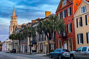 Historic Charleston, South Carolina street with colorful homes and a church steeple
